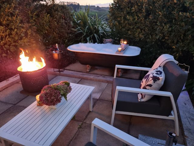 An outdoor space with a fire pit and a bathtub at Country Idyll Hut 2 – Sandspit Holiday Cottage Sandspit