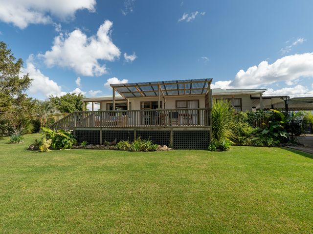 A house with a deck and garden at Calden Cottage - Ngurunguru Holiday Home Ngunguru