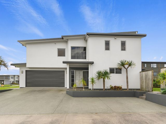 A house with a garage and driveway at Seaside Escape - Ruakaka Holiday Home Ruakaka