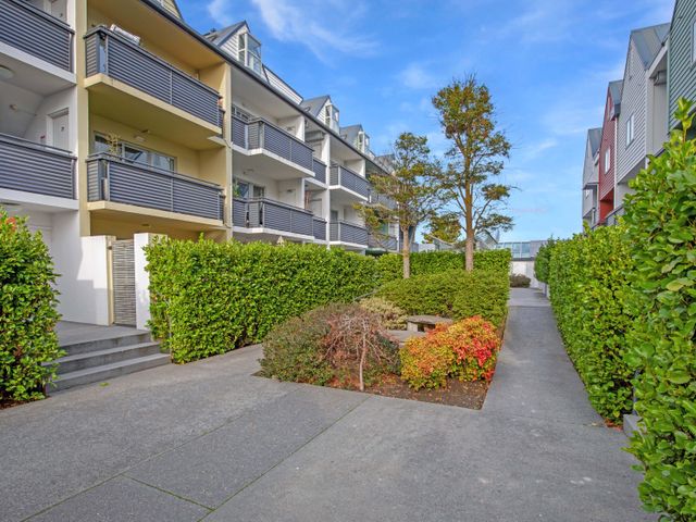 An outdoor area with buildings, a walkway, and greenery at Urban Oasis - Christchurch Holiday Home Christchurch