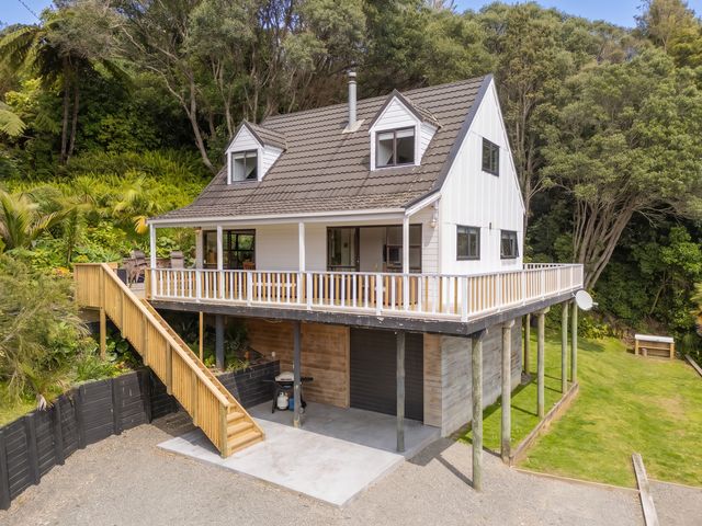 A house with a deck and staircase in an outdoor area at Skipper’s view - Onemana Holiday Home, Onemana