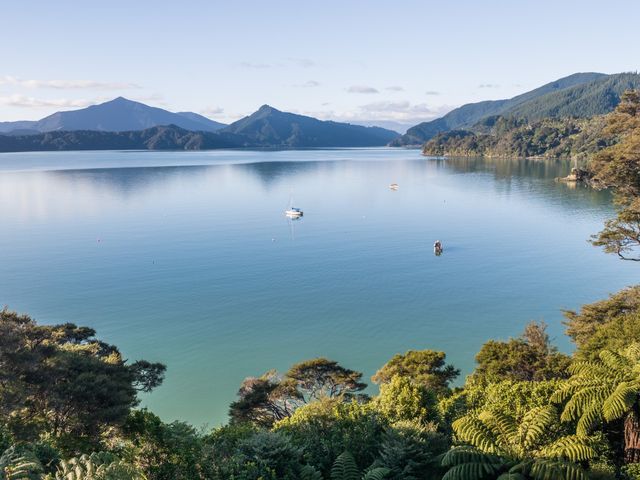A view of a waterbody and mountains at The Bay house - Moetapu Holiday Home, Moetapu Bay