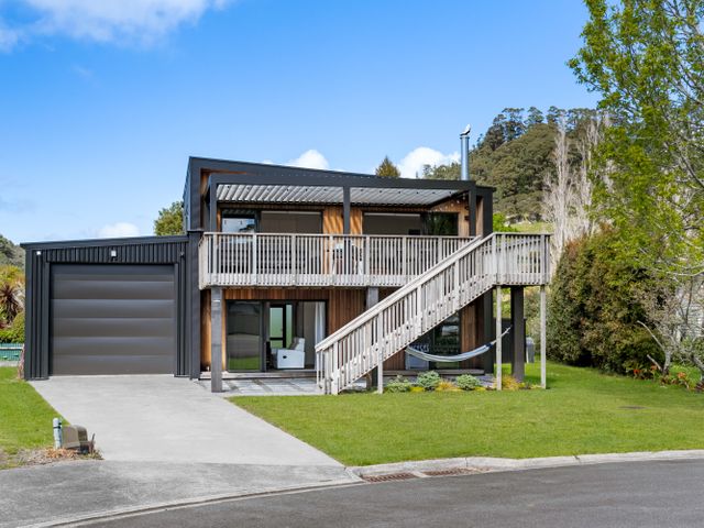 A house with garage and deck at The Cove Escape - Cooks Beach