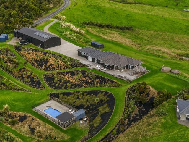An outdoor area with a house and a swimming pool at Waipu Hilltop Escape - Waipu Cove