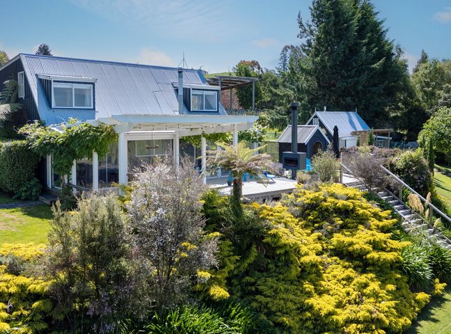 A house with a deck and garden at Pukawa Country Lodge - Pukawa Bay