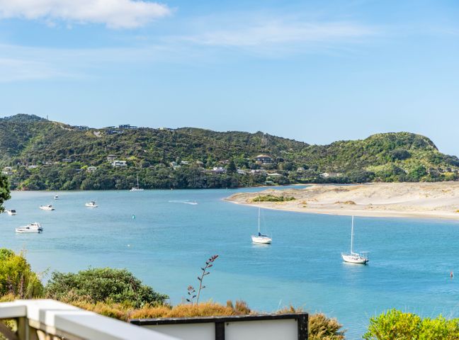 A view of a waterway with boats and houses on hills at Harbourview Haven - Mangawhai Heads Holiday Home in Mangawhai Heads