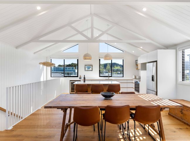A dining room with a table and chairs at Waihi Beach Holiday Home in Waihi Beach