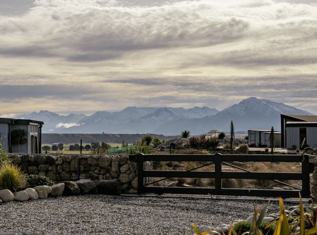 A view of mountains and buildings at Eight on Jackson - Luggate Holiday Home