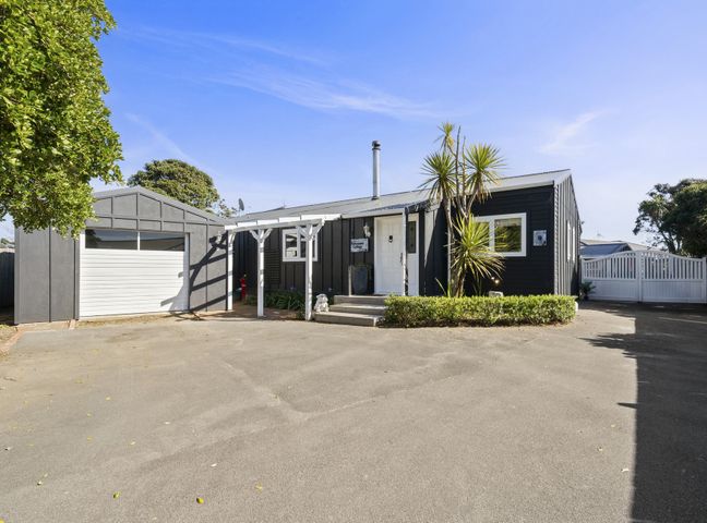 A house with a garage and pathway in front at the property in location