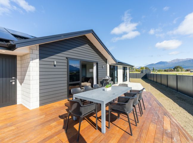 An outdoor dining area with a table and chairs at Oraka Scenery - Te Anau