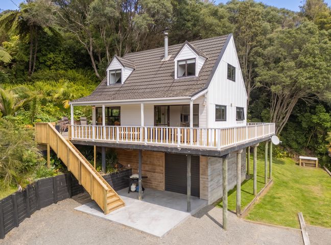 A house with a deck and staircase in an outdoor area at Skipper’s view - Onemana Holiday Home, Onemana