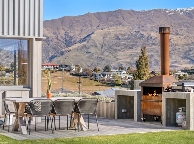 An outdoor patio with a table and chairs at Peak Perspective - Wanaka Holiday Home, Wanaka