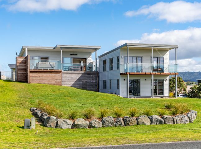 Two modern houses with balconies on a green lawn at Starling - Mangawhai Heads Holiday Home Mangawhai Heads