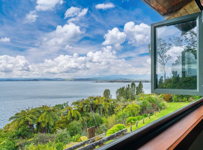 A view of water and trees from a window at Fern View - Pukawa Bay Holiday Home Pukawa Bay