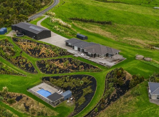 An outdoor area with a house and a swimming pool at Waipu Hilltop Escape - Waipu Cove