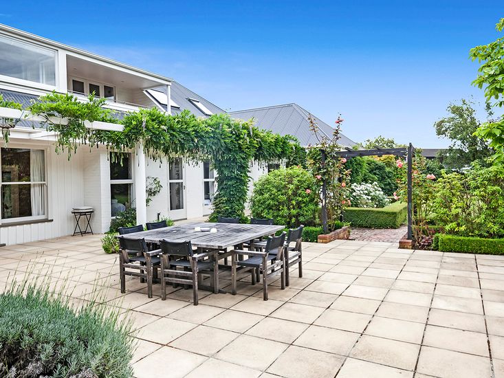 Large outdoor dining table and access to manicured gardens