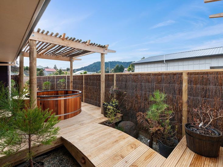 Cedar spa pool in the landscaped garden and outdoor area