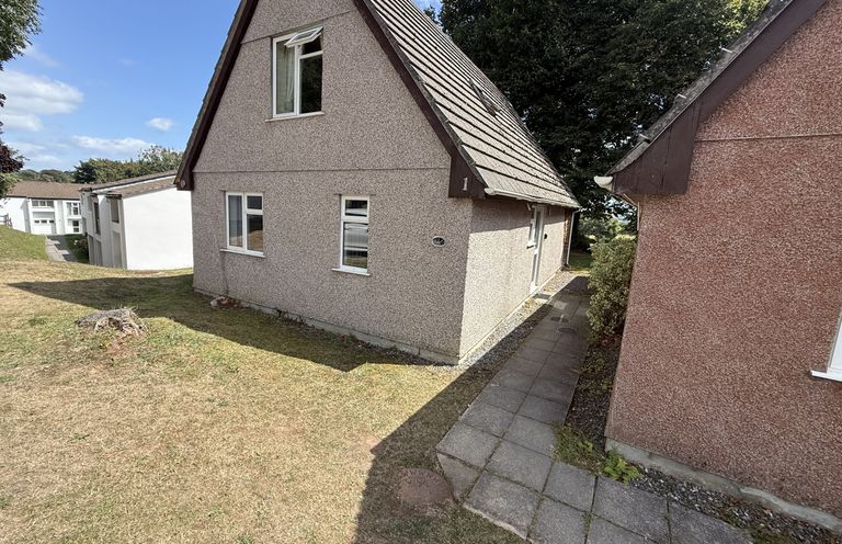 A house with pathway and grass at Hembry Meadows in Honicombe Park near Gunnislake