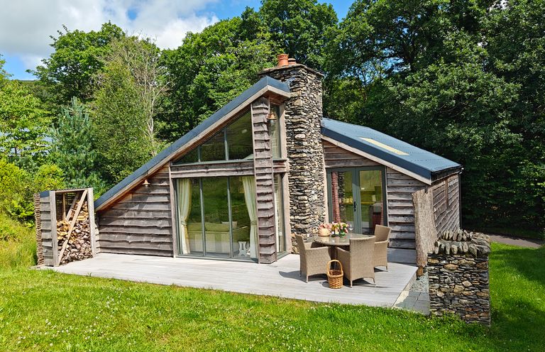 A cabin with a deck and outdoor seating area at The Badger's Shack, Garnett Bridge, Longsleddale. Near Kendal