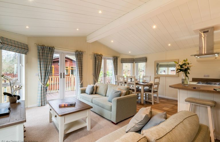 A living room with two sofas a coffee table and a dining table with chairs at Langdale Lodge Langdale 21 White Cross Bay near Windermere