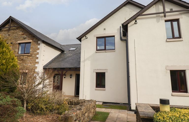 A house with stone and white walls and a small garden at Tilly Mint Cottage Nr Ullswater