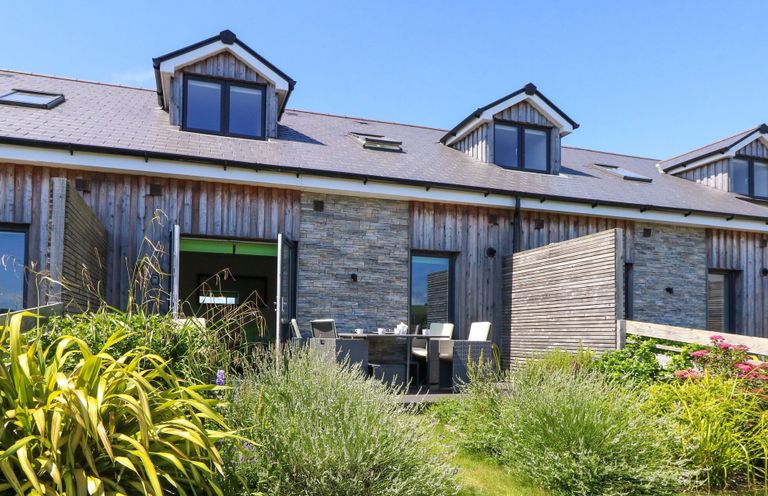 A building with an outdoor seating area and garden at Overcombe Mill Nottington near Weymouth