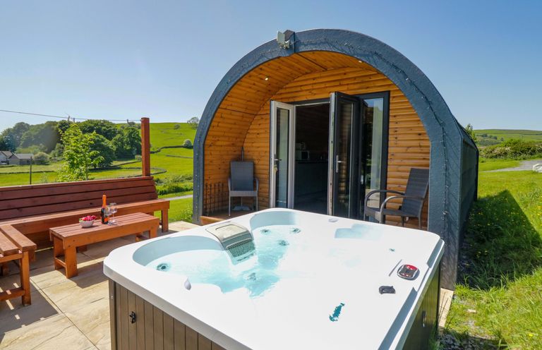 An outdoor area with a hot tub and seating at Beech in Ulverston