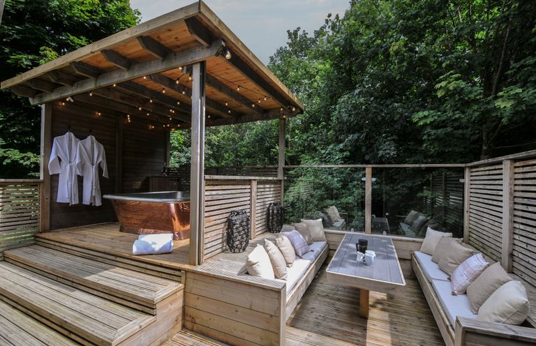 An outdoor spa area with a bath and seating at 24 Meadow Retreat Dobwalls