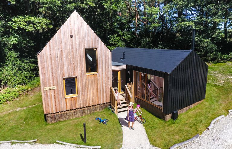 A house with wooden exterior and garden at Lodge 19 in Corfe Castle