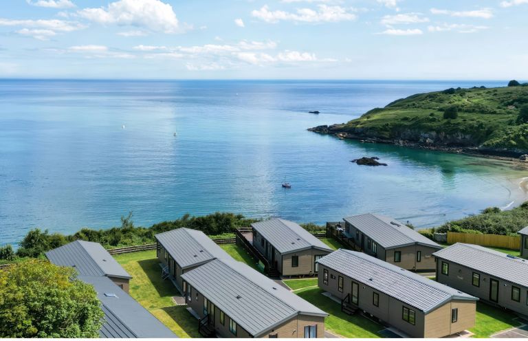 View of cabins overlooking the sea at Lodge 65 at Riviera Bay Coastal Retreat in Brixham