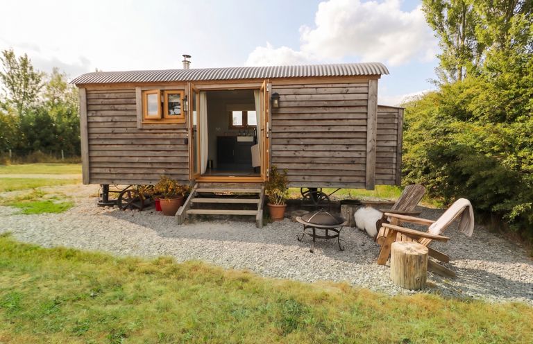 A trailer with steps and seating area at Cariad Mawr in Gwaenysgor near Prestatyn