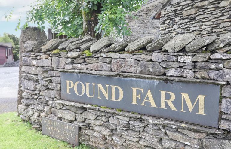 A stone wall with sign at Pound Farm Crook near Kendal