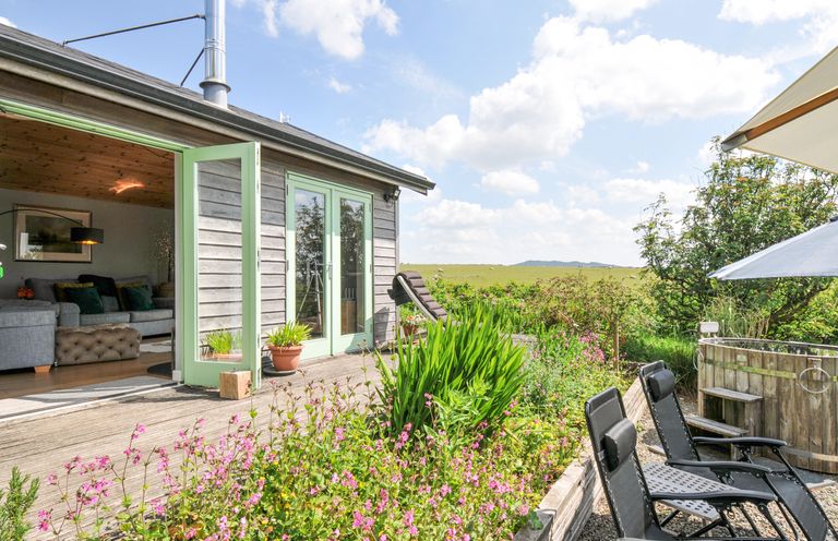 An outdoor area with seating and flowers at Smugglers Bodmin Moor, St Breward near St Tudy