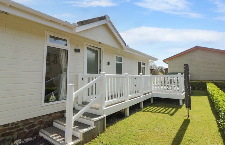 An outdoor area with a white deck and steps at Erisa in Stepaside
