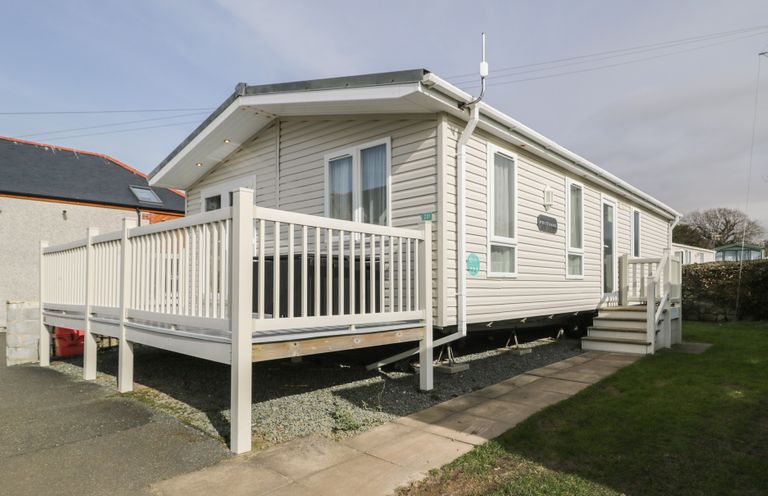 A mobile home with a deck and steps at Gold Lodge (201) Talybont