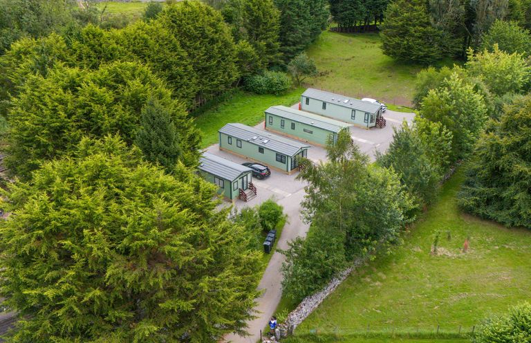 An outdoor area with cabins and trees at Lodge 4 in Silverdale