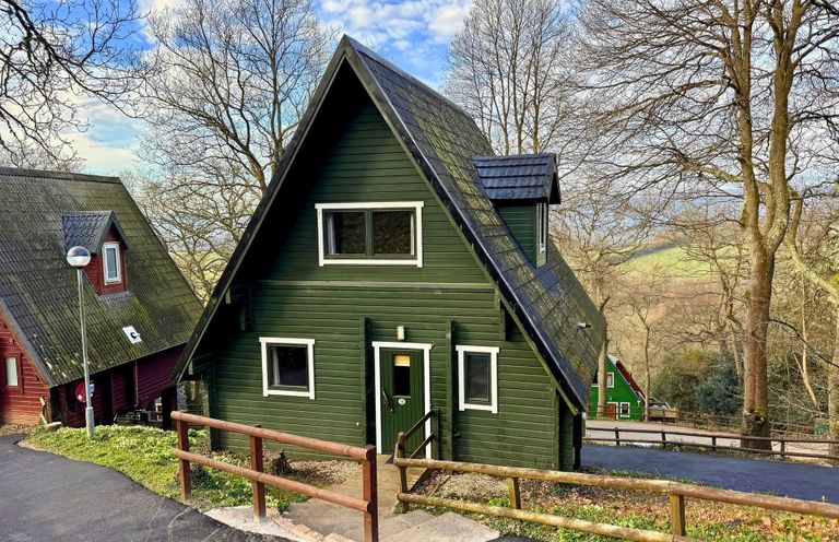 A house with green exterior and a pathway at Tor View, Finlakes Holiday Park near Chudleigh