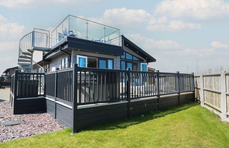 A house with a deck and staircase in an outdoor area at Life's a Beach Bacton