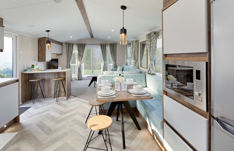 A living room with a table set for dining at Island Breeze - Hayling Island
