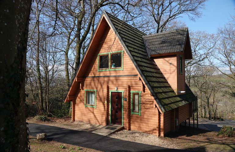 A cabin surrounded by trees at Acorn Lodge Finlakes Holiday Park near Chudleigh