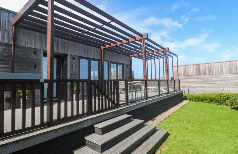 An outdoor area with a deck and stairs at Lodge 83, Gwel an Mor Portreath