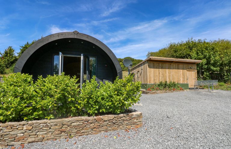 An outdoor area with buildings and plants at Thelma’s Lodge near Pontyates