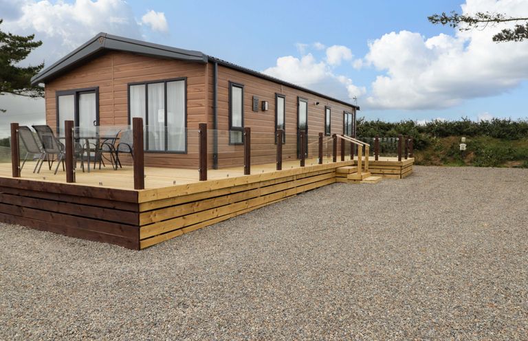A house with a deck and chairs at Dolphin in Haverfordwest