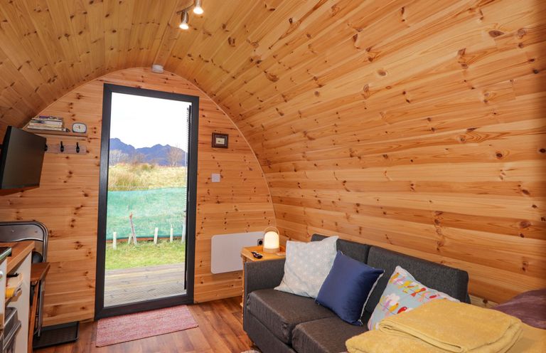 A living room with a sofa and television at The Pod at Greenbank Isle of Skye