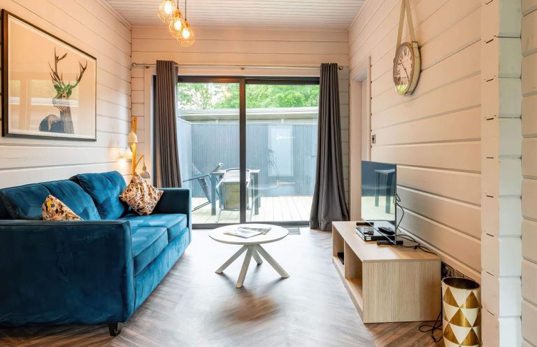 A living room with a sofa and television at Askrigg in Aysgarth
