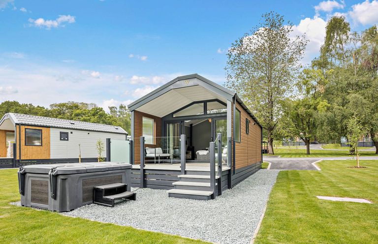 An outdoor space with a house and hot tub at Prion Spa in Llandyrnog