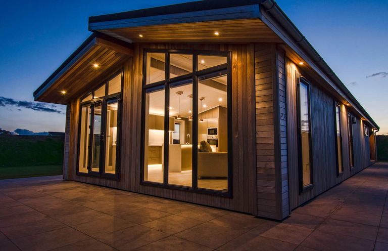 An exterior view of a modern house with large windows at Darwin Retreat in Wigton