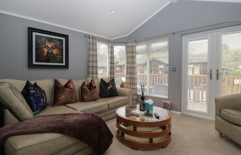 A living room with a sofa and coffee table at 32 Grasmere, White Cross Bay near Windermere