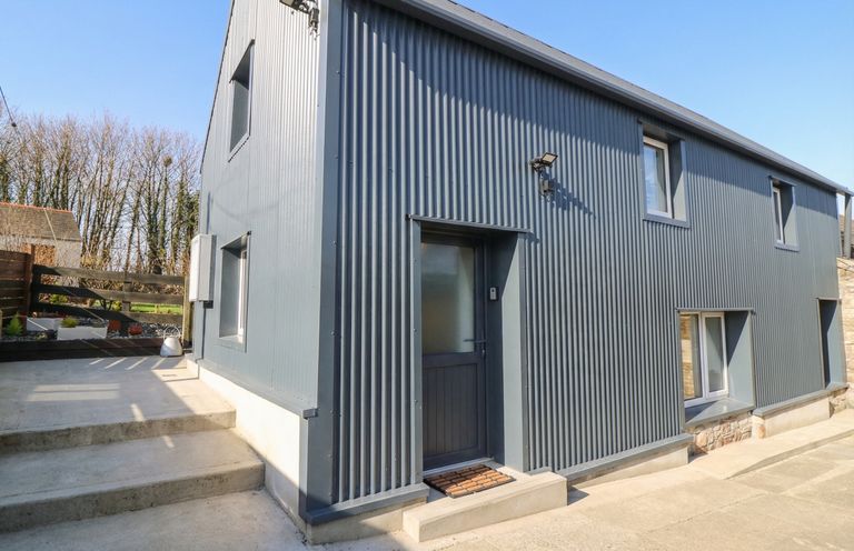 An exterior view of a modern house with a door and windows at The Loft in Glenmore, County Kilkenny