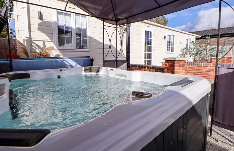 A hot tub in an outdoor setting at Lodge in Talacre